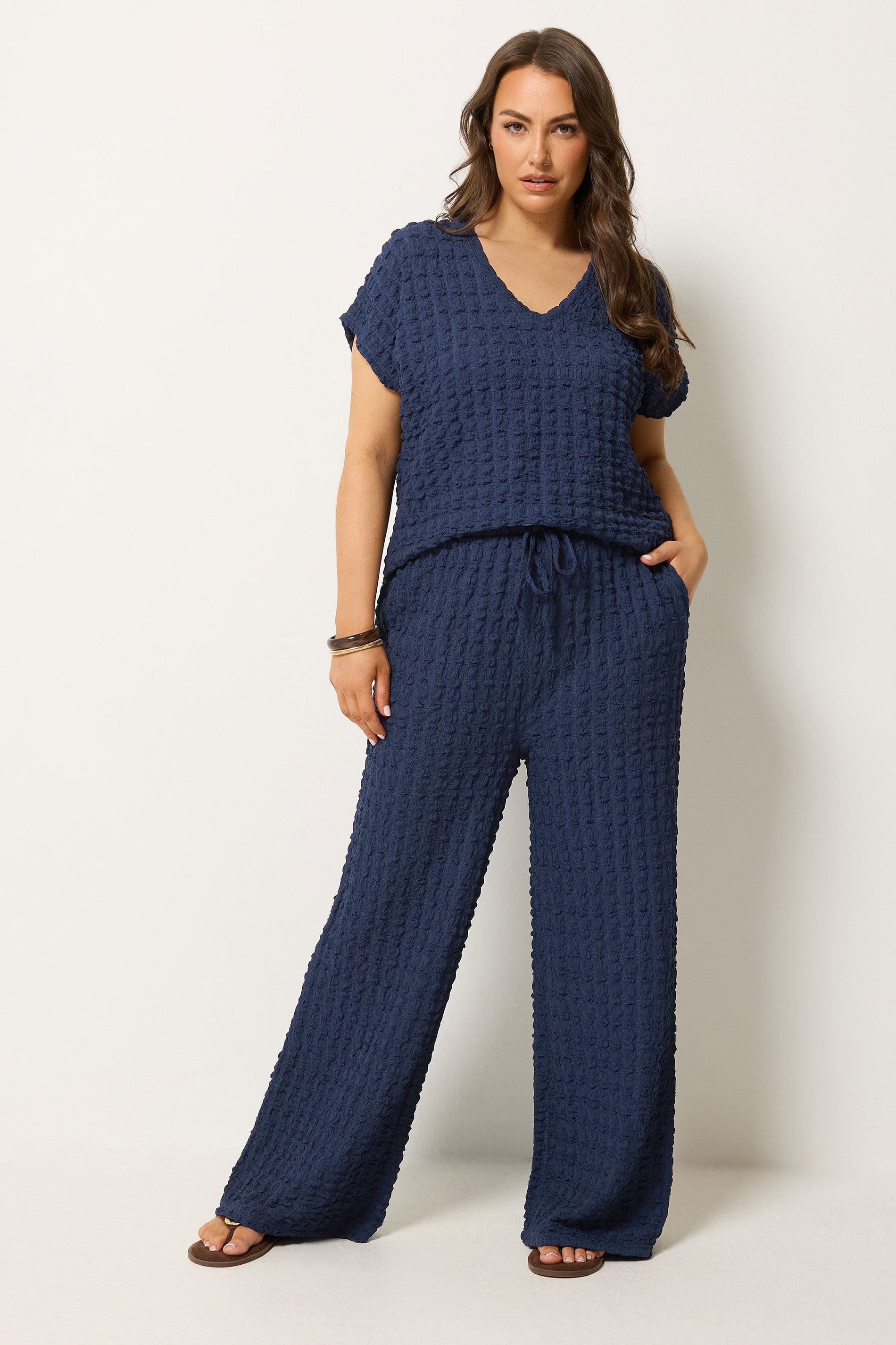 YOURS Plus Size Navy Blue Bubble Textured Wide Leg Trousers | Yours Clothing 1