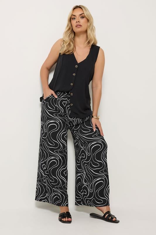 YOURS Plus Size Black Swirl Wide Leg Trousers | Yours Clothing 1