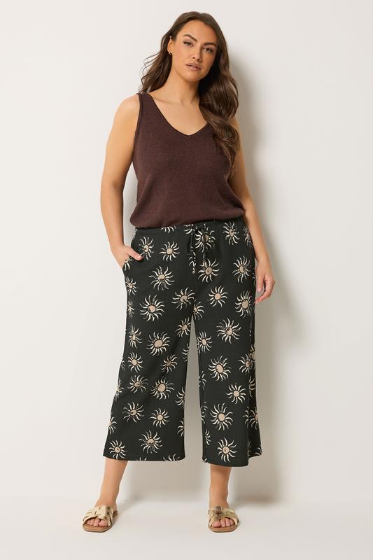 YOURS Plus Size Black Sun Print Cropped Wide Leg Trousers | Yours Clothing 1