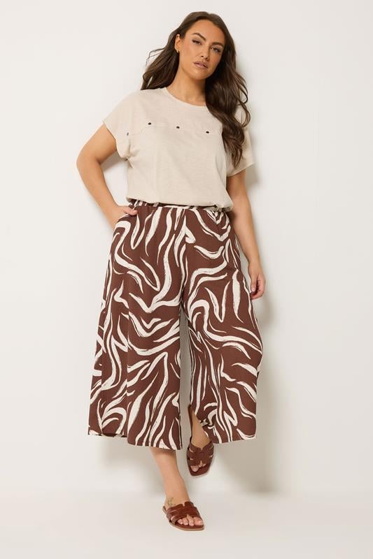 YOURS Plus Size Brown Abstract Cropped Wide Leg Trousers | Yours Clothing 1