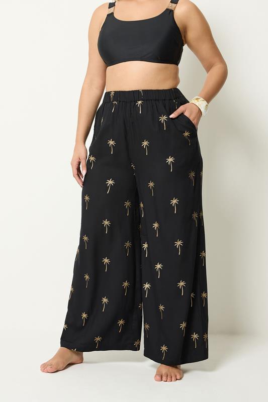 YOURS Plus Size Black Foil Palm Tree Beach Trousers | Yours Clothing 1