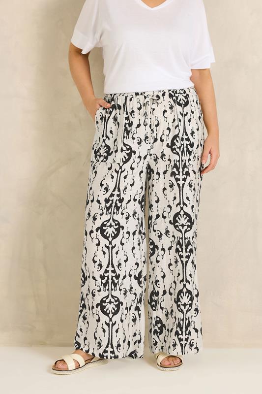 EVANS Plus Size White Abstract Print Wide Leg Trousers | Evans 1