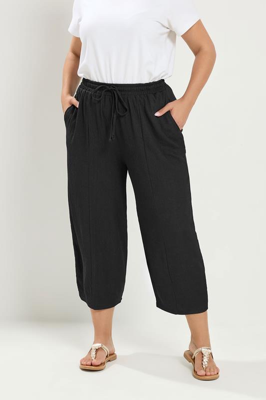 YOURS Plus Size Black Crinkle Barrel Trousers | Yours Clothing 1