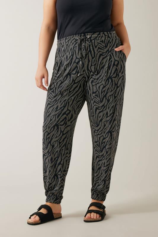 EVANS Plus Size Black Animal Markings Jersey Tapered Trousers | Evans 1