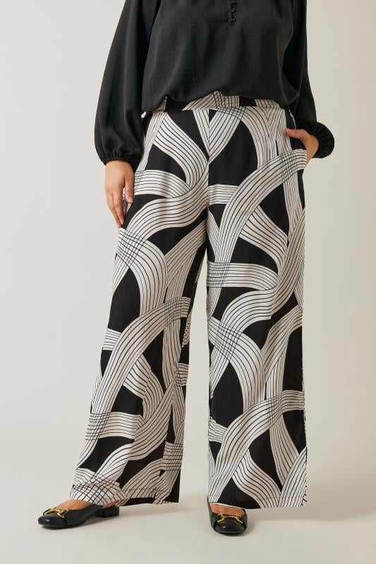 EVANS Plus Size Black Linear Print Wide Leg Trousers | Evans 1