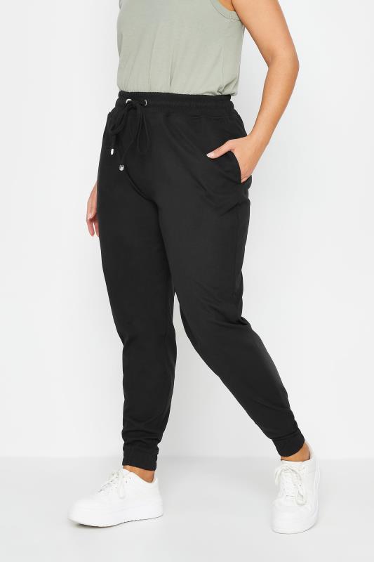 YOURS Plus Size Black Cuffed Elasticated Stretch Joggers | Yours Clothing 1
