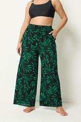 YOURS Plus Size Black & Green Leaf Print Crinkle Beachwear Wide Leg Trousers | Yours Clothing 1